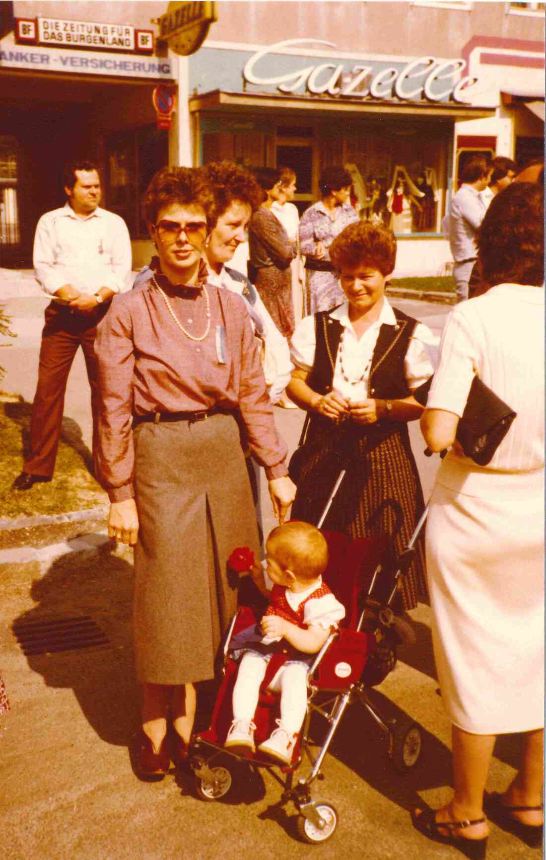 Fam. Miertl als Zuschauer beim Umzug des Bezirkserntedankfests 1981 vor dem Haus Hauptplatz 5 mit einer Gazelle-Filiale (Pomper/Langer)