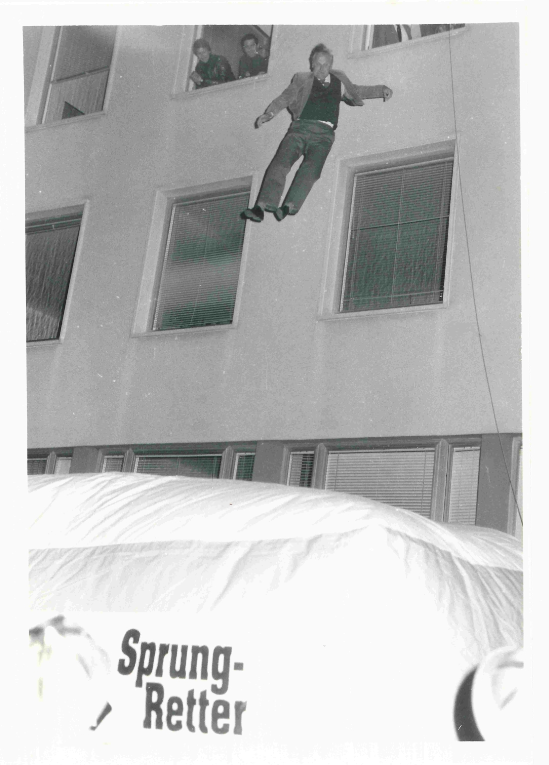 Arch. DI Rudolf Schober (Bausachverständiger der Stadtgemeinde) testet den Sprungpolster der Feuerwehr durch einen Sprung aus dem 2. Stock der Bezirkshauptmannschaft
