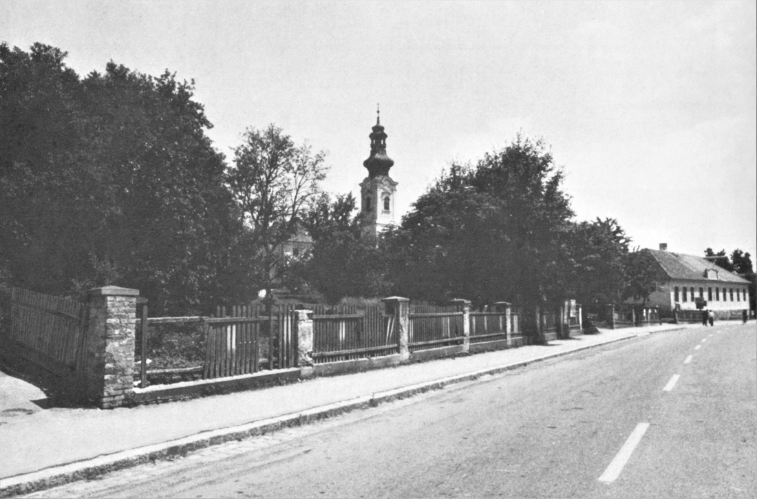 Blick entlang der Steinamangererstraße auf die röm. kath. Kirche und rechts die Schule